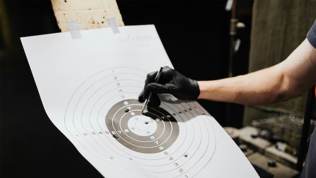 shooter checking marks on the target